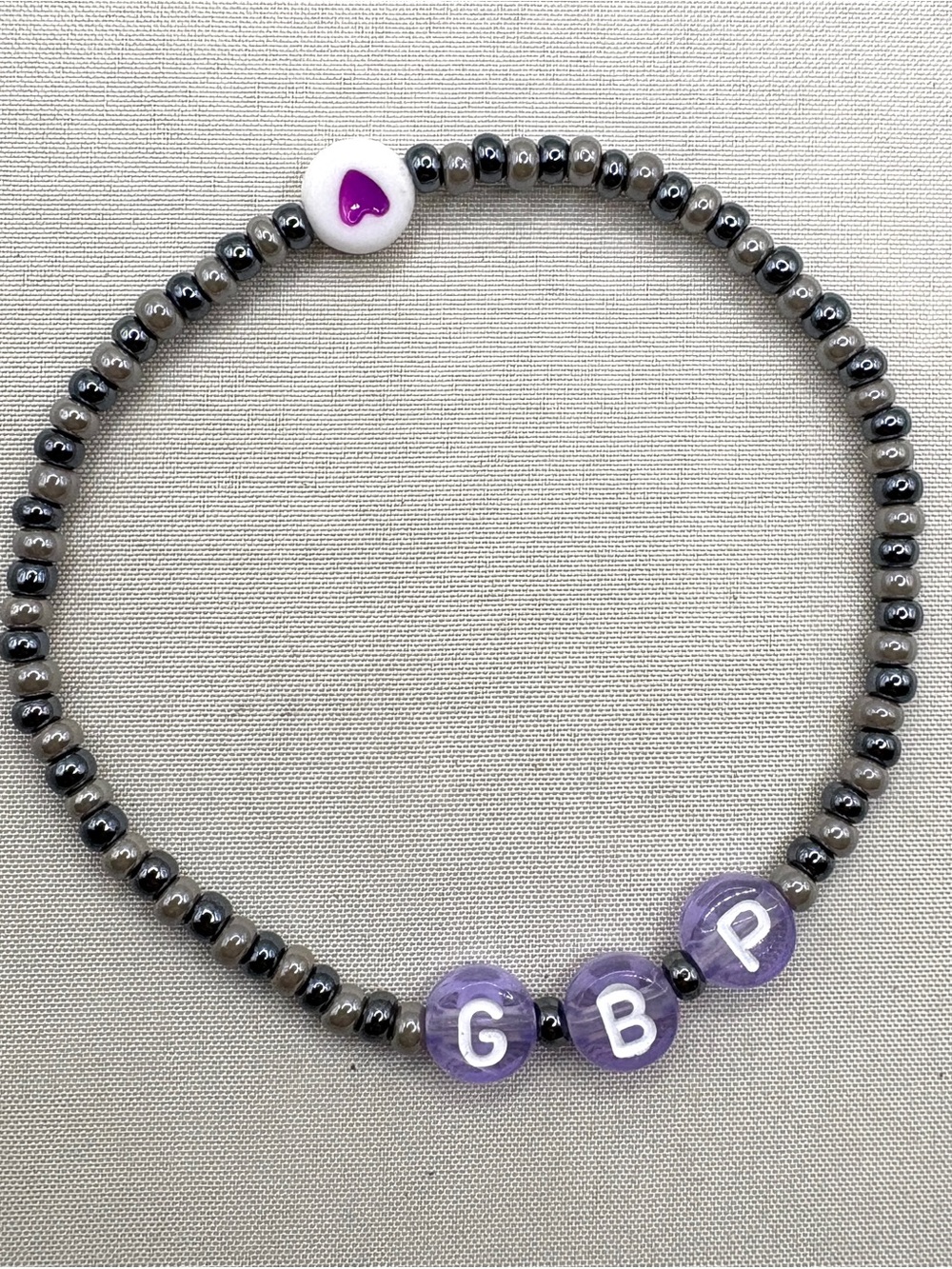 Purple Letter Bead GBP Go Big Purple Stretch Bracelet with black and gray Beads